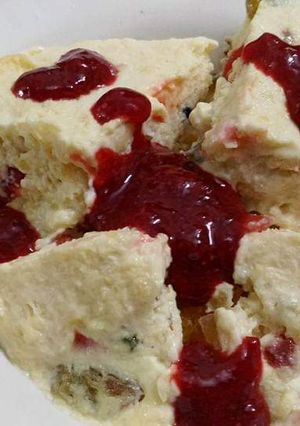 A picture of Butterscotch pudding with strawberry sauce.