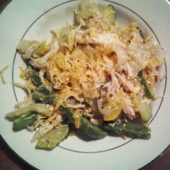 A picture of Veggies and chicken with cheese.
