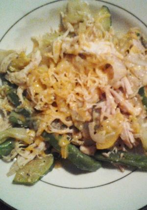 A picture of Veggies and chicken with cheese.