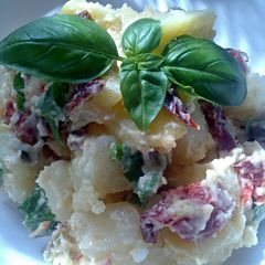 A picture of Sig's potato salad with sun-dried tomato, chorizo and pistachio nuts,.