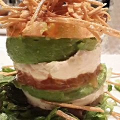 A picture of Vertical tomato avocado goat cheese salad.