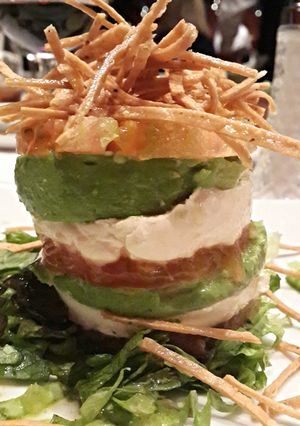 A picture of Vertical tomato avocado goat cheese salad.