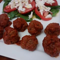 A picture of Meatballs with spicy tomato sauce.