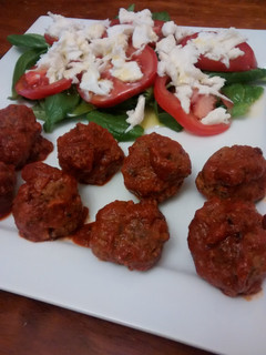 A picture of Meatballs with spicy tomato sauce.