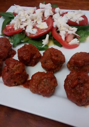 A picture of Meatballs with spicy tomato sauce.
