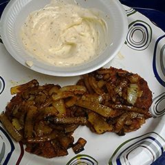 A picture of Tuna cakes with curried onions and curry sauce.