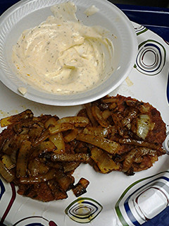 A picture of Tuna cakes with curried onions and curry sauce.