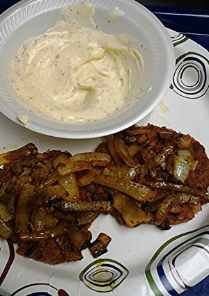 A picture of Tuna cakes with curried onions and curry sauce.