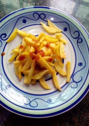 A picture of Fries and ketchup.