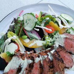 A picture of Marinated Lamb saddle, citrus beet salad with Ranch dressing.