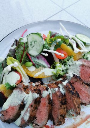 A picture of Marinated Lamb saddle, citrus beet salad with Ranch dressing.