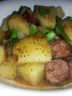 A picture of Smothered smoked sausage and potatoes.