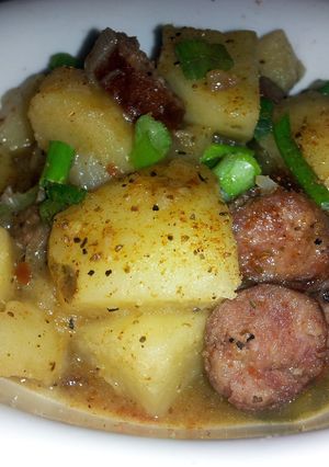 A picture of Smothered smoked sausage and potatoes.