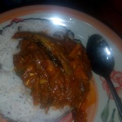 A picture of Rice and beans with smoked fish stew.