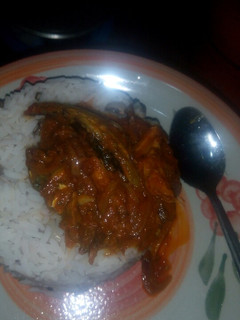 A picture of Rice and beans with smoked fish stew.