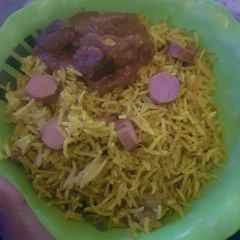 A picture of Basmati fried rice with sausages.