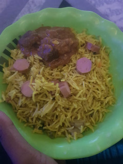 A picture of Basmati fried rice with sausages.