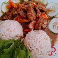 A picture of Rice and pork meat sauce.