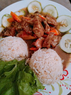 A picture of Rice and pork meat sauce.