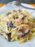 Tallarines cremosos a la naranja con langostinos y shiitake