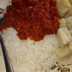 A picture of Rice and stew with yam.