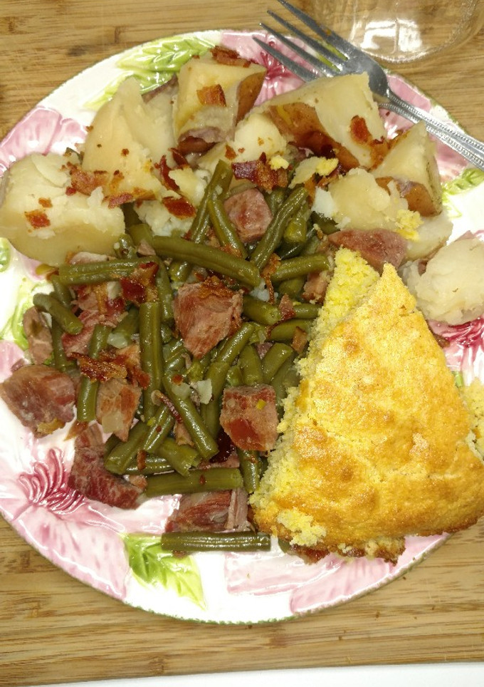A picture of Ham and Beans with Potatoes and Cornbread.