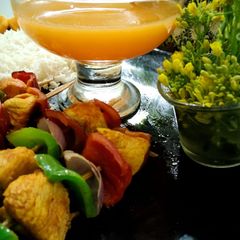 A picture of Juicy shaslik sticks with orange juice.