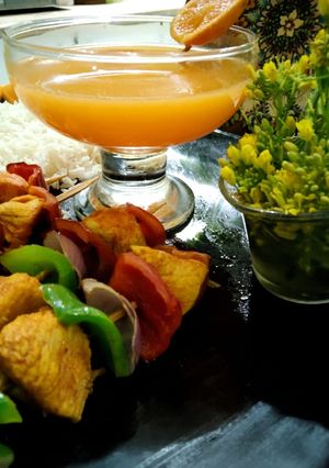 A picture of Juicy shaslik sticks with orange juice.