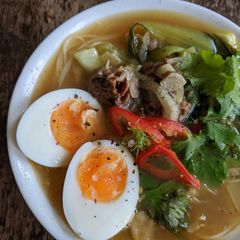 A picture of Beef bone broth with noodles.