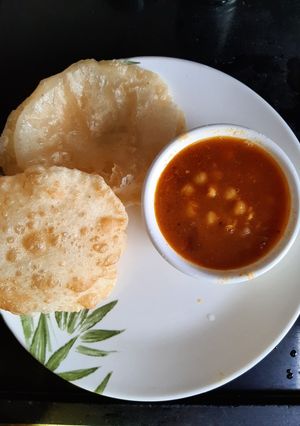 A picture of Chole bature or refined flour puris.