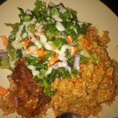A picture of Jallof rice and salad.