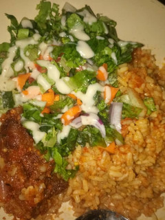 A picture of Jallof rice and salad.