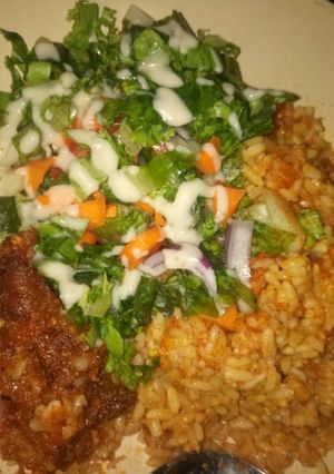 A picture of Jallof rice and salad.