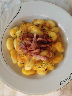 A picture of Potato Gnocchi with Pumpkin Cream and Crispy Speck.