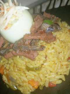 A picture of Fried rice,peppered liver and sausage with coleslaw.