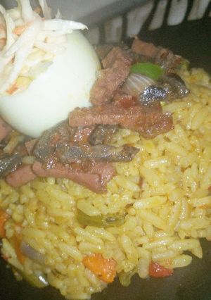 A picture of Fried rice,peppered liver and sausage with coleslaw.