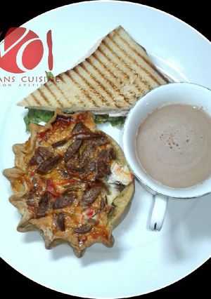 A picture of Gizzad sandwich with choco drink.