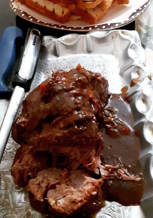 A picture of Roast beef with brown sauce.