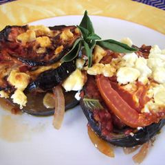 A picture of Eggplants with cheese in the oven.