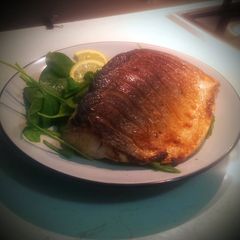 A picture of Crispy Skin Salmon with Spinach Salad.