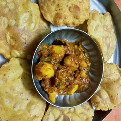 Atte ki masaledar puri and aloo tamatar ki sabji A picture of Atte ki masaledar puri and aloo tamatar ki sabji.