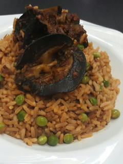 A picture of Jollof rice with snail.