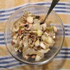 A picture of Endive salad with mushrooms and walnuts.