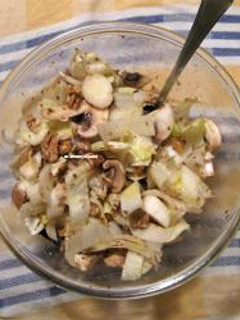 A picture of Endive salad with mushrooms and walnuts.