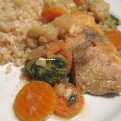 A picture of Salmon filet stew with carrots, brocoli and cauliflower.