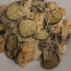 A picture of Vermicelli rice noodles with mushrooms, courgettes and prawns.