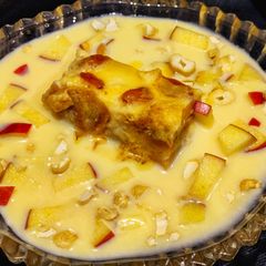 A picture of Eggless Bread pudding with vanilla custard sauce.