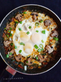 A picture of Spinach mushroom with egg in Shakshuka style.