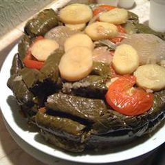 A picture of Stuffed vine leaves with olive oil.