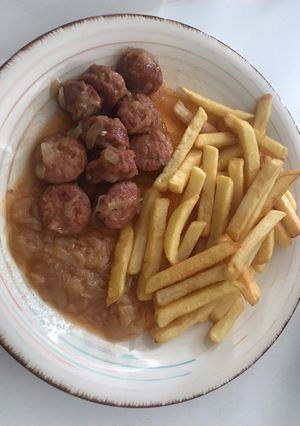 Una foto de Longanizas con papitas y cebolla frita